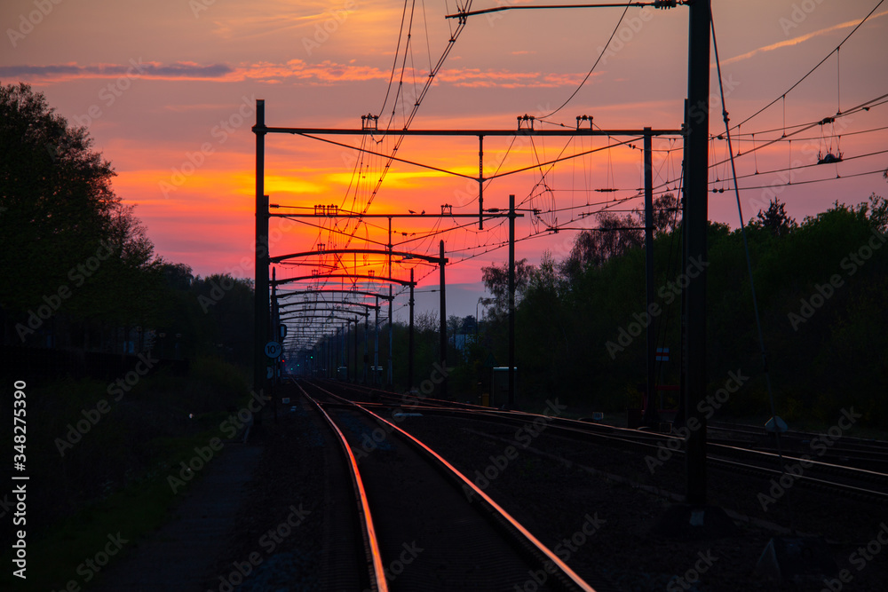 Sunset at over the railroad with reflective rails