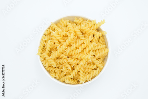 Twisted macaroni shot on a white isolated background.