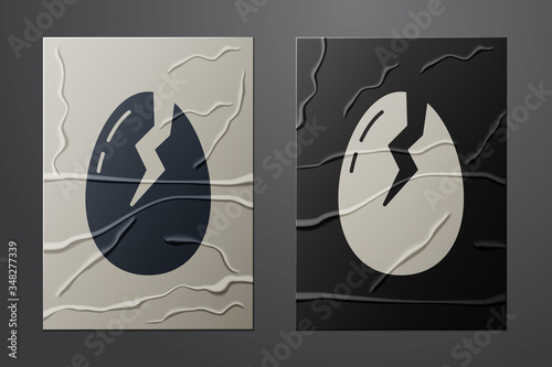 White Broken egg icon isolated on crumpled paper background. Happy Easter. Paper art style. Vector
