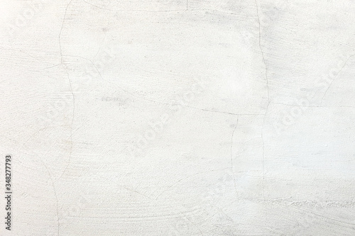 Abstract weathered texture stained old stucco light gray and aged paint white brick wall background in rural room.
