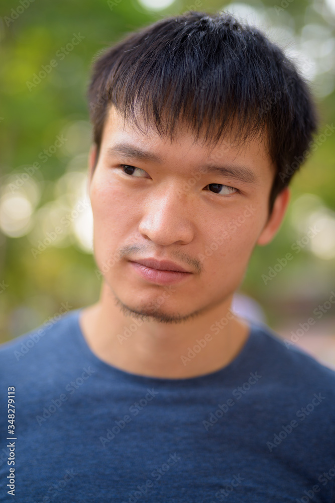 Portrait of young Asian man at the park outdoors Portrait of young Asian man at the park outdoors
