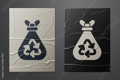 White Garbage bag with recycle symbol icon isolated on crumpled paper background. Trash can icon. Recycle basket sign. Paper art style. Vector
