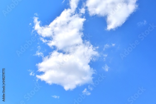 Beautiful blue sky and white fluffy clouds.  natural background with cloudscape. Pure azure sky with idyllic cumulus. 