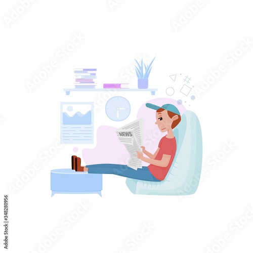 A young man reads a newspaper on self-isolation. Sitting in a chair legs lie on a sofa