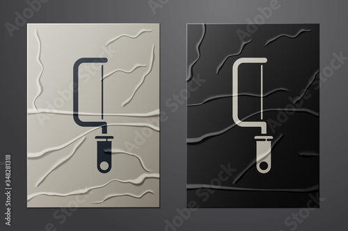 White Hacksaw icon isolated on crumpled paper background. Metal saw for wood and metal. Paper art style. Vector