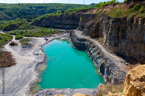 Abandoned granite and sand quarry with a lake. Stone extraction in the canyon.