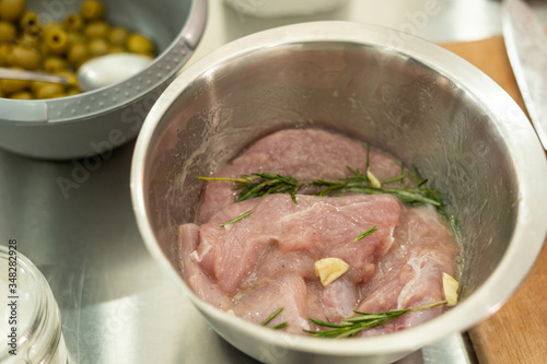 Turkey fillet being marinated with garlic and rosemary