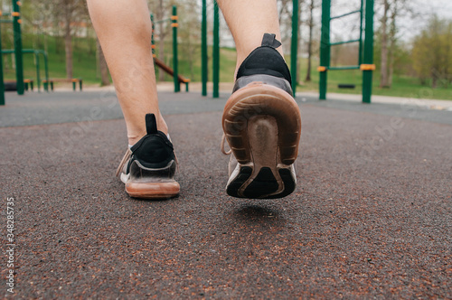 Running athlete during training outdoors in the summer on a sunny day. photo