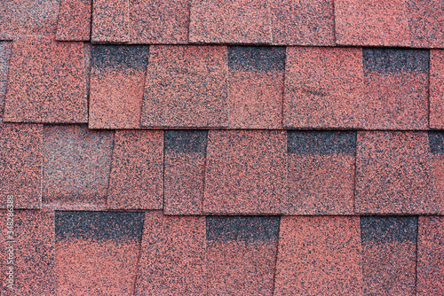 Red shingles for covering the roof. Building material flexible tile background.
