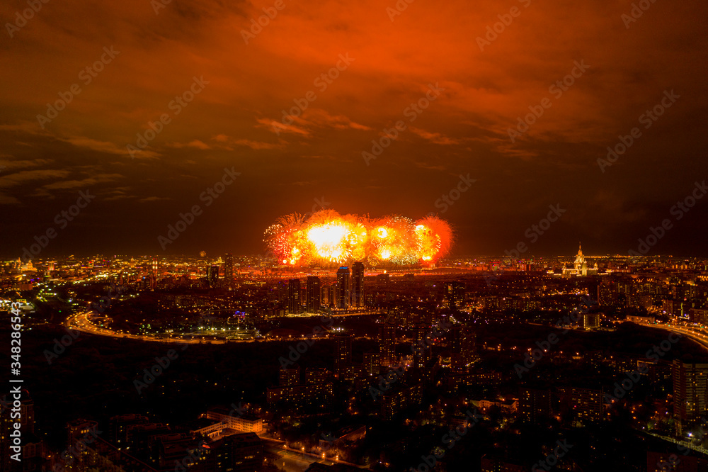Fototapeta premium fireworks in the center of a big city at night filmed from a drone
