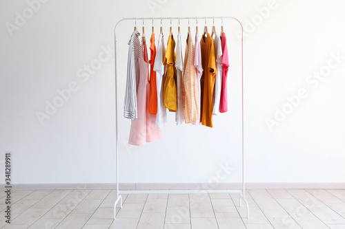 fashion clothes on a stand in a light background indoors. place for text

