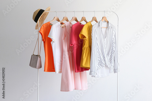 fashion clothes on a stand in a light background indoors. place for text
