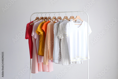 fashion clothes on a stand in a light background indoors. place for text
