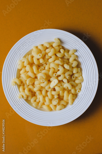 Macaroni on a white plate with butter