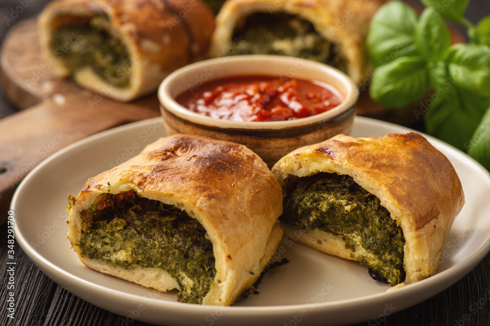 Stromboli with spinach and mozzarella fiiling., italian pizza dough pie. Stromboli with spinach and mozzarella fiiling., italian pizza dough pie.