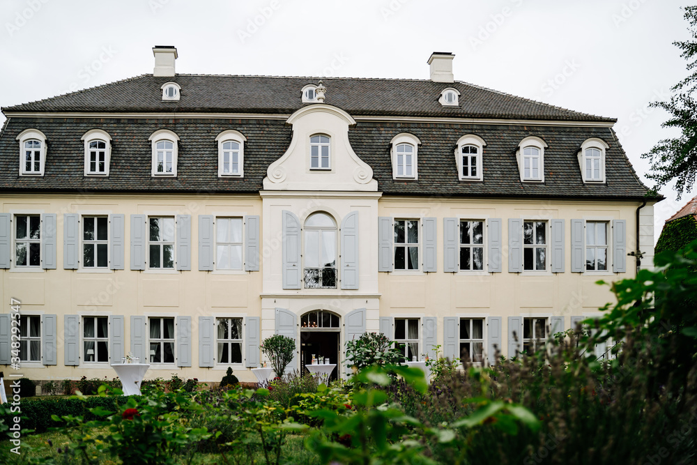 photo of an old white big house in the garden