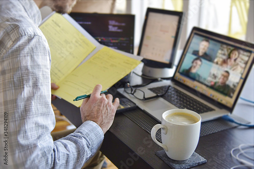 Signing documents while using video chat on computer screens. 