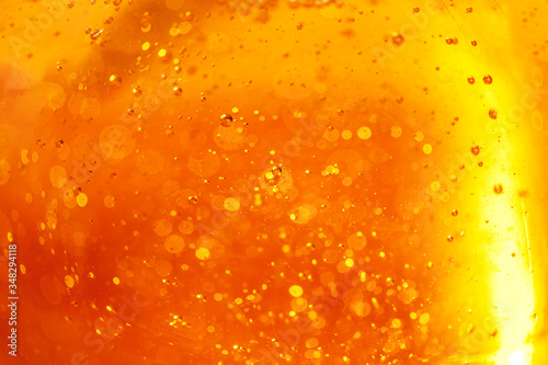 Lot of small bubbles on an orange background, macro shot of liquid soap, macro shot of glass with beer, macro shot of cocktail with fruit juice