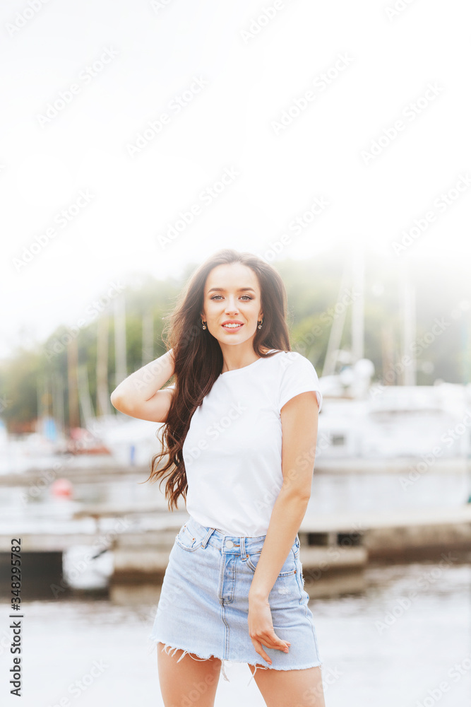 Young beautiful happy woman walks on beach in marina Young beautiful happy woman walks on beach in marina