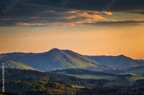 Mountainous landscape at sunset at spring time. View from the top of the Bosmany rocky hill above the Kostolec village in northwestern Slovakia, Europe.