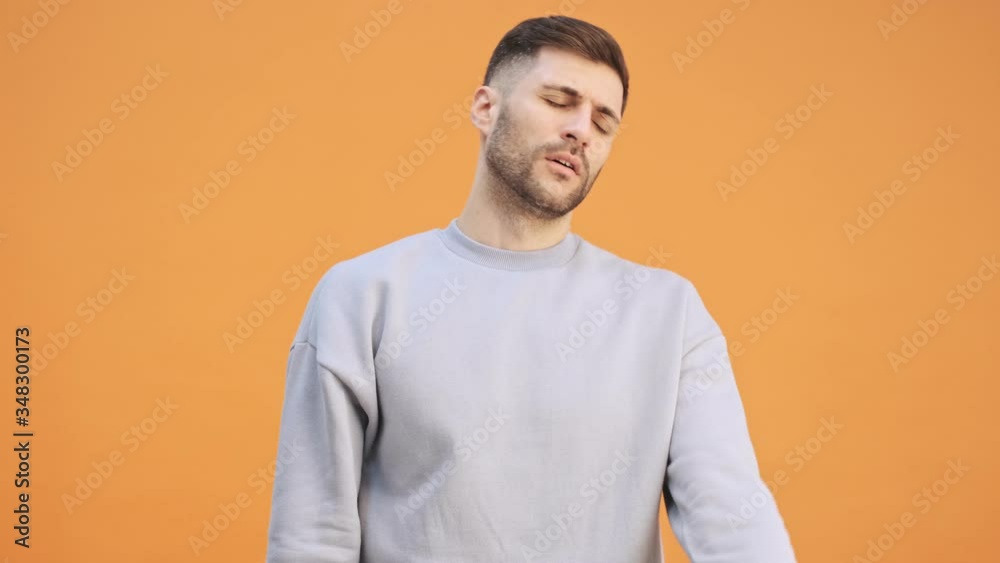Young displeased man isolated over yellow wall background Young displeased man isolated over yellow wall background