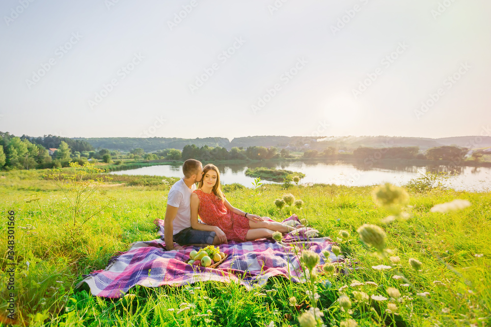 Love story of a beautiful young man and woman. Loving couple sit Love story of a beautiful young man and woman. Loving couple sit