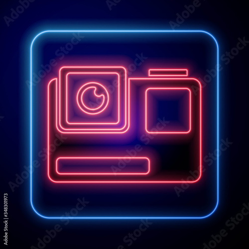 Glowing neon Action extreme camera icon isolated on blue background. Video camera equipment for filming extreme sports. Vector