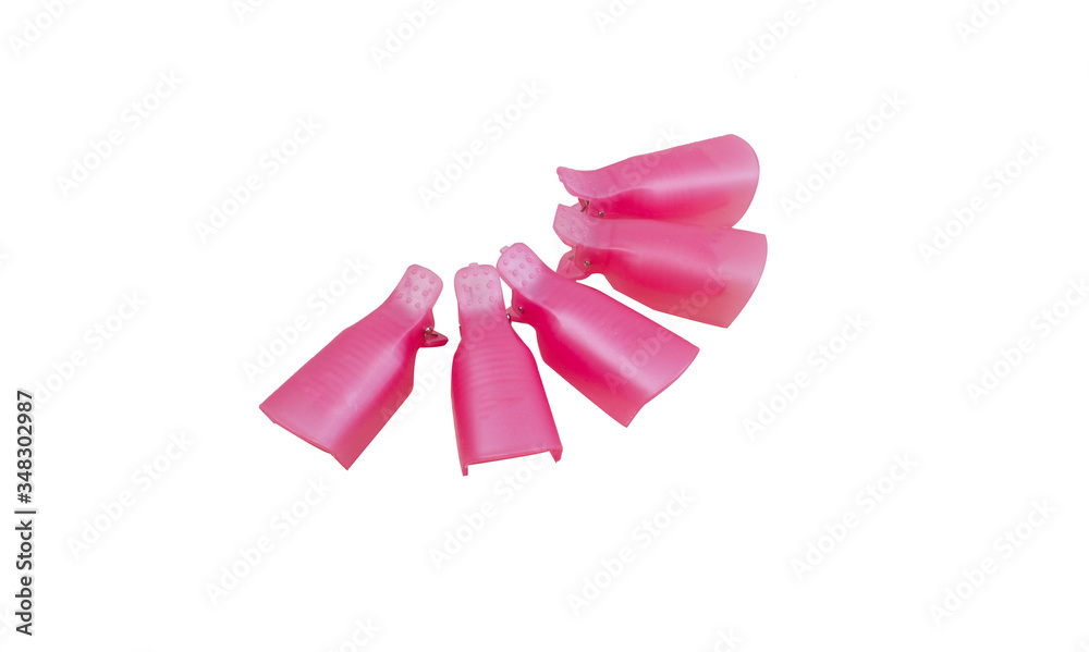 Pink plastic protective caps for nails isolated on a white background. Tools for procedure manicure and pedicure. Help in removing gel lacquer from nails. Pink plastic protective caps for nails isolated on a white background. Tools for procedure manicure and pedicure. Help in removing gel lacquer from nails.