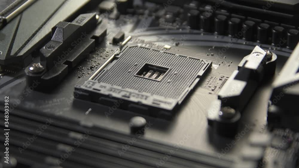 Motherboard with processor close up tilt shot. Computer components on circuit board Motherboard with processor close up tilt shot. Computer components on circuit board