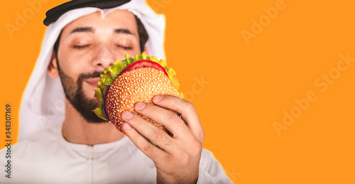 Photography Close-up of  Arab man and a burger