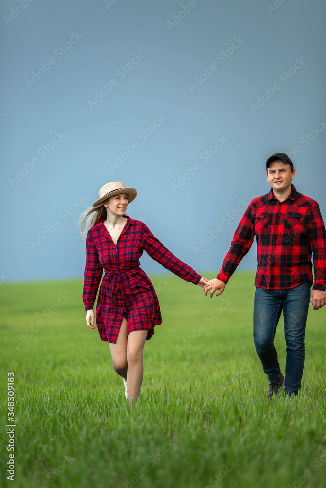 Typical landscape of a field with crops with a couple of farmers. Typical landscape of a field with crops with a couple of farmers.