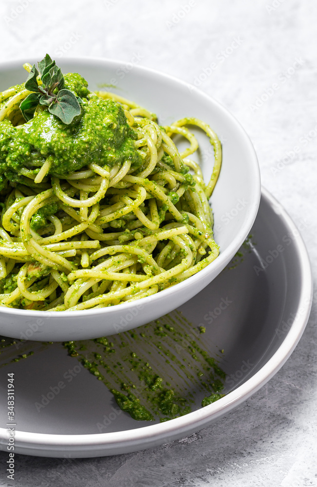 Spaghetti with homemade pesto sauce on gray background Spaghetti with homemade pesto sauce on gray background