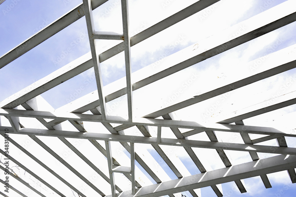 A canopy from polycarbonate arc. Metalware on the blue sky A canopy from polycarbonate arc. Metalware on the blue sky