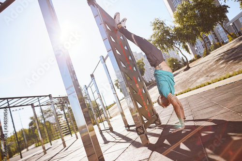 Wallpaper Mural Staying in great shape. Strong and healthy mature or middle aged man in sportswear doing handstand while training outdoors in the morning Torontodigital.ca