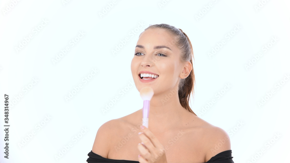 Beauty concept. The girl is blushing with a brush on a white background. 4k Resolution. Beauty concept. The girl is blushing with a brush on a white background. 4k Resolution.