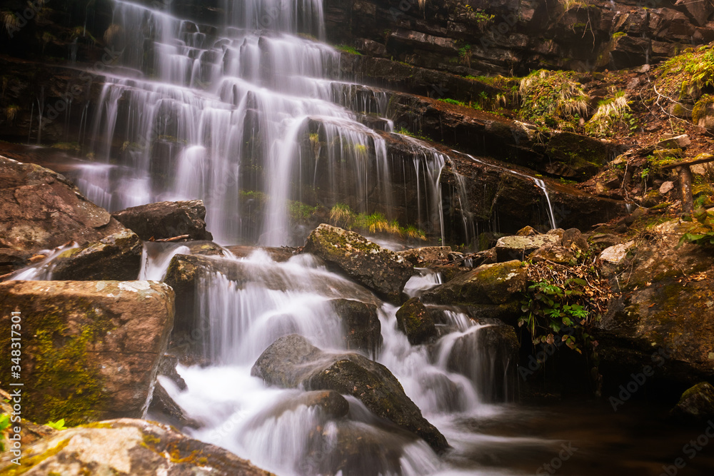 Fototapeta premium Waterfall in a forest on mountain. Called Tupavica waterfall on old mountain (stara planina) near the village Dojkinci in Serbia