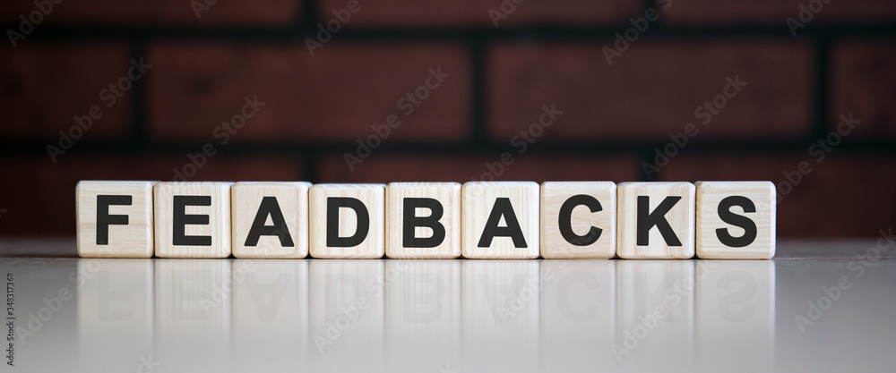 Feadbacks - text on cubes with reflection in the background of the kirie
