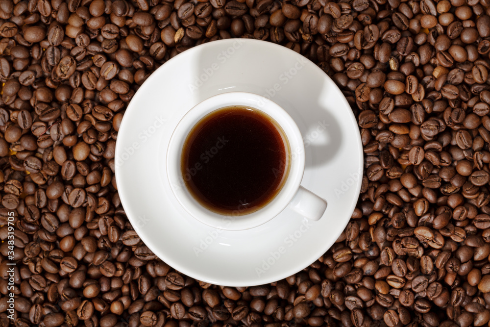 Top view of Espresso Coffee cup on roasted coffee beans background Top view of Espresso Coffee cup on roasted coffee beans background