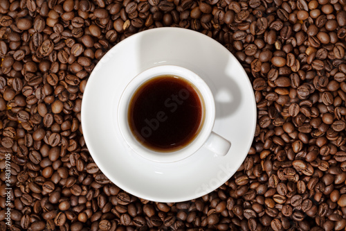 Top view of Espresso Coffee cup on roasted coffee beans background