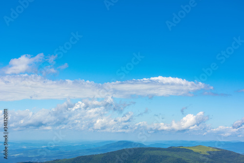 white fluffy clouds on the blue sky. beautiful nature scenery in mountains
