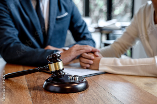 Judge gavel and two golden marriage ring, Contract decree of divorce (dissolution or cancellation) of marriage, husband and wife during divorce process and signing of divorce contract