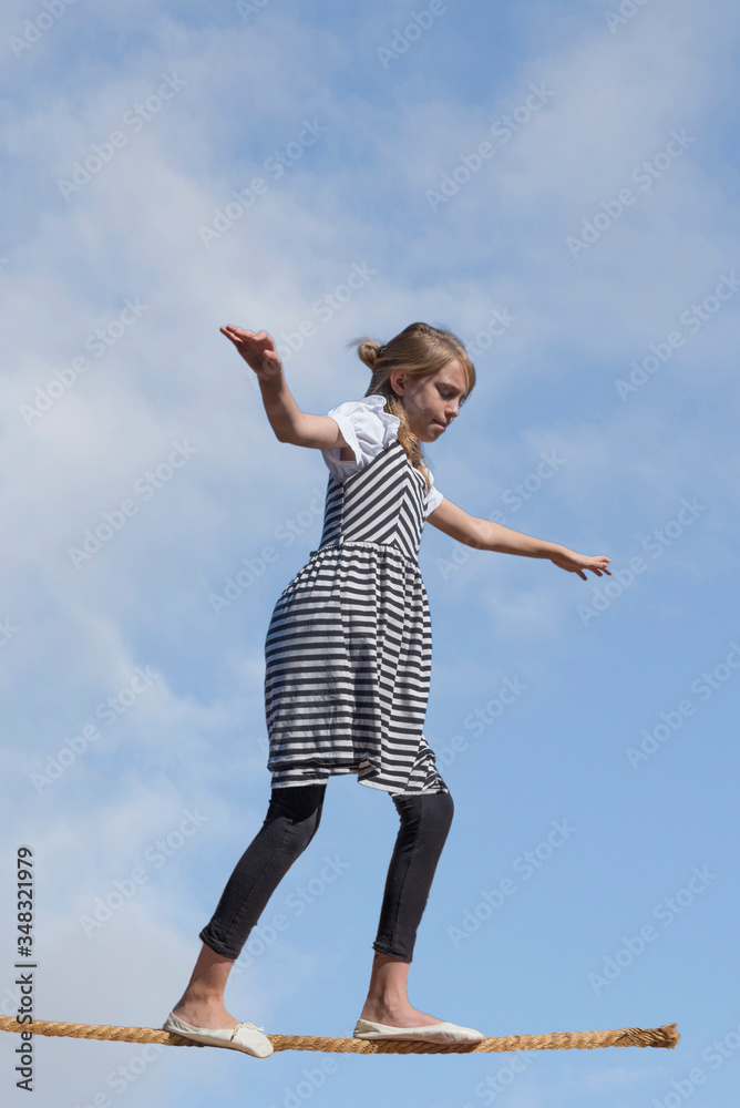 Photo concept art of young girl on tightrope representing the process of growing up and making decisions, but rope is coming to an end, Photo concept art of young girl on tightrope representing the process of growing up and making decisions, but rope is coming to an end,
