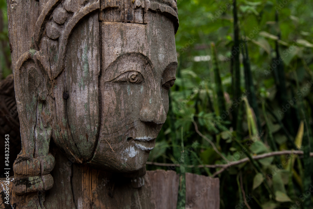 wooden totem pole in a forest 