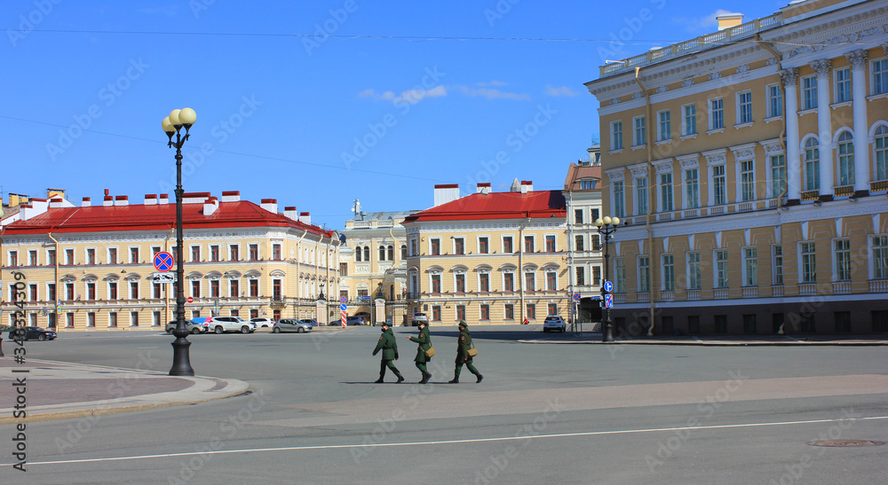 Military man walking on empty street in Saint Petersburg, Russia. City street with patrol during self-isolation regime during covid-19 pandemic in St Petersburg