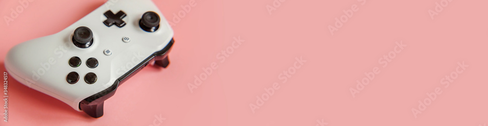 White joystick gamepad game console isolated on pastel pink colourful trendy pin-up background. Computer gaming competition videogame control confrontation concept. Cyberspace symbol Banner White joystick gamepad game console isolated on pastel pink colourful trendy pin-up background. Computer gaming competition videogame control confrontation concept. Cyberspace symbol Banner
