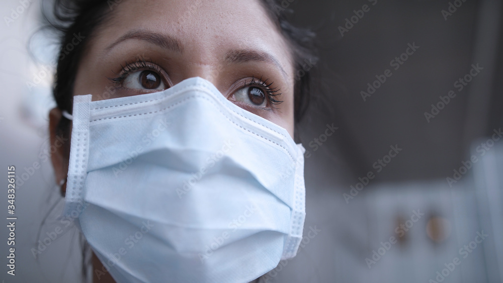 Closeup of nurse with mask outside coronavirus infection room