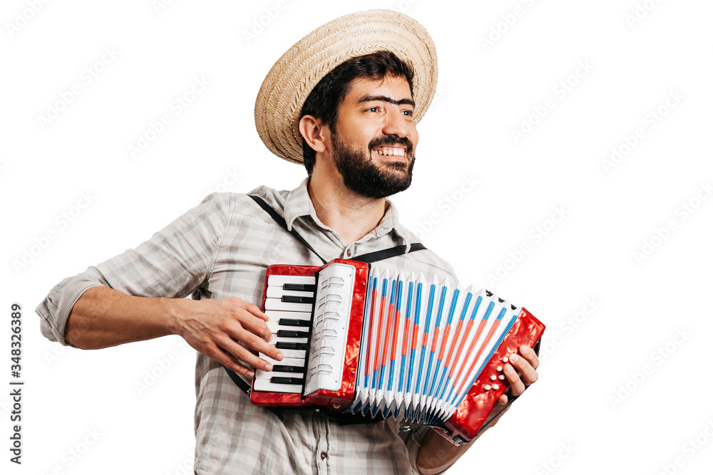 Brazilian man wearing traditional clothes for Festa Junina - June festival - playing toy accordion Brazilian man wearing traditional clothes for Festa Junina - June festival - playing toy accordion