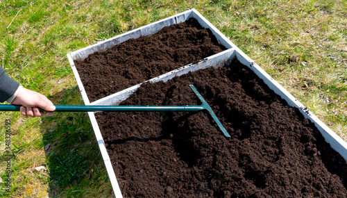 Level the ground with a rake to make to prepare garden bed