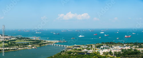 Panorama view of Singapore City skyline and business logistic sea going ship