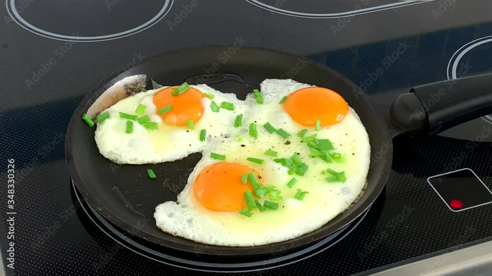 Cooking eggs with green onion in a frying pan Cooking eggs with green onion in a frying pan